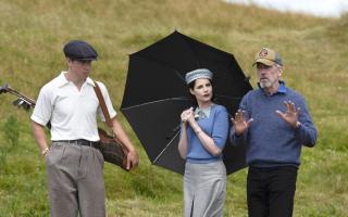 Lucy Boynton and Will Poulter with director Hugh Laurie on the set of Why Didn't They Ask Evans? Picture: (c) Mammoth Screen/Agatha Christie Limited/BritBox