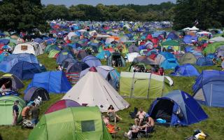 Music fans by their tents at Latitude festival. Credit: PA