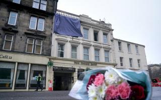 Flowers left outside New County Hotel after the fatal fire at the start of January.