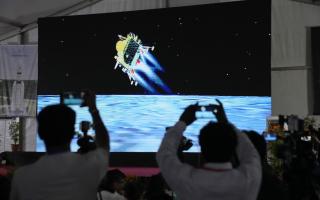 Journalists film the live telecast of spacecraft Chandrayaan-3 landing on the moon at the Indian Space Research Organisation's facility in Bengaluru