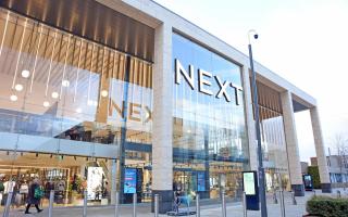 Retailer Next defies expectations and hints at falling prices