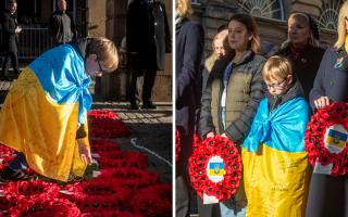 Ukrainian refugees Marichka, 16, and Sviatoslav, nine, lay poppy wreaths for their father Koli in Edinburgh