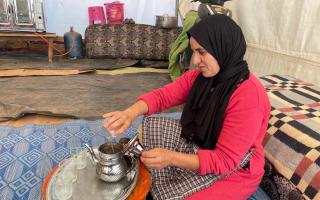 Rachida pours the tea in the communal kitchen