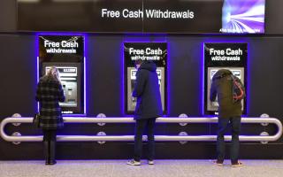 People withdraw cash from free ATM cash machines