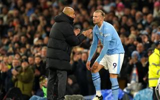Manchester City manager Pep Guardiola speaks with Erling Haaland (Martin Rickett/PA)