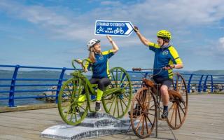 A sculpture of the world's first pedal bike has been unveilled at the start point of a cycle route named after its inventor