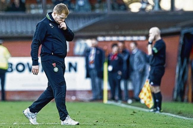 A thoughtful Neil Lennon trudges off the pitch after watching his side lose two late goals at Tannadice. Picture: SNS