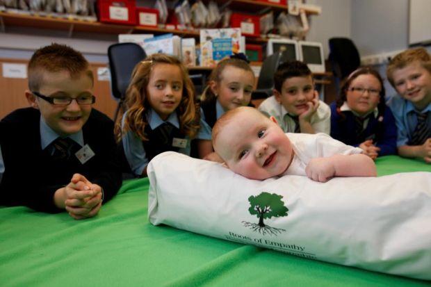 EARLY LEARNING: Baby Chloe Quigley, 14 weeks, with pupils from New Stevenson Primary School in North Lanarkshire during a demonstration of the new initiative. Picture: Martin Shields