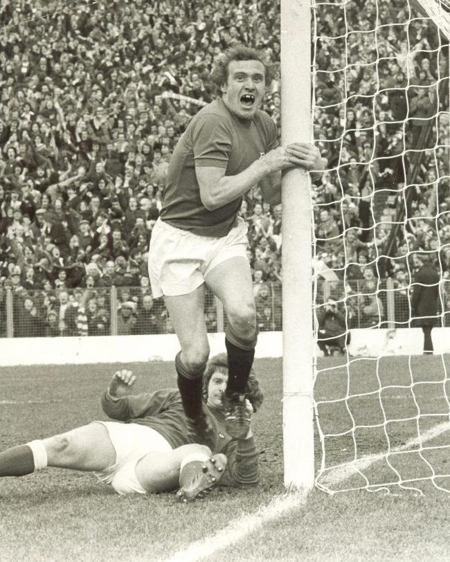 Colin Stein peels himself off the post to celebrate his headed goal against Hibs that won Rangers the Scottish title in 1975. Picture: Alex Wilson