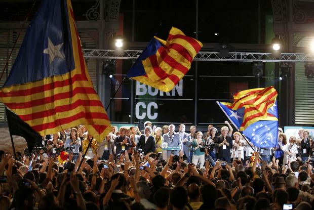 HeraldScotland: Junts Pel Si (Together For Yes) supporters wave flags while Catalan President Artur Mas and other politicians take the stage after polls closed in a regional parliamentary election in Barcelona REUTERS/Sergio Perez