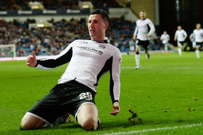 Michael O'Halloran slides in celebration after scoring St Johnstone's third against Rangers in the League Cup