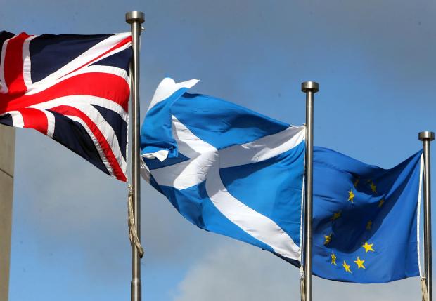 HeraldScotland: UP IN THE AIR: The Union Flag, the Saltire and European Union flag flying at the Scottish Parliament building. The future relationship of Scotland and the EU is being hotly debated. Picture: Gordon Terris