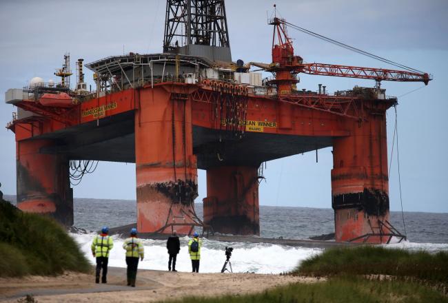 The Transocean Winner drilling rig is seen off the coast of the Isle of Lewis after it ran aground in severe weather conditions. PRESS ASSOCIATION Photo. Picture date: Tuesday August 9, 2016. The oil rig, which is carrying 280 tonnes of diesel, is being m