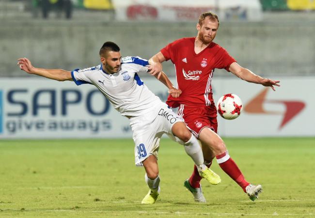 Aberdeen's Mark Reynolds clashes with Apollon Limassol's Anton Maglica on a disappointing night in Cyprus   Photograph: SNS.