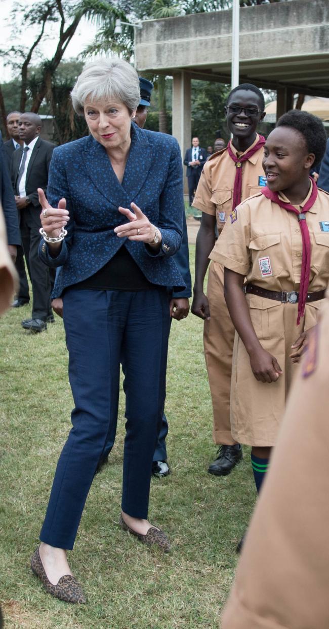 RECROPPED: Prime Minister Theresa May breaks into dance whilst meeting with Scouts at the United Nations offices in Nairobi on the third day of her visit to Africa. PRESS ASSOCIATION Photo. Picture date: Thursday August 30, 2018. See PA story POLITICS Afr