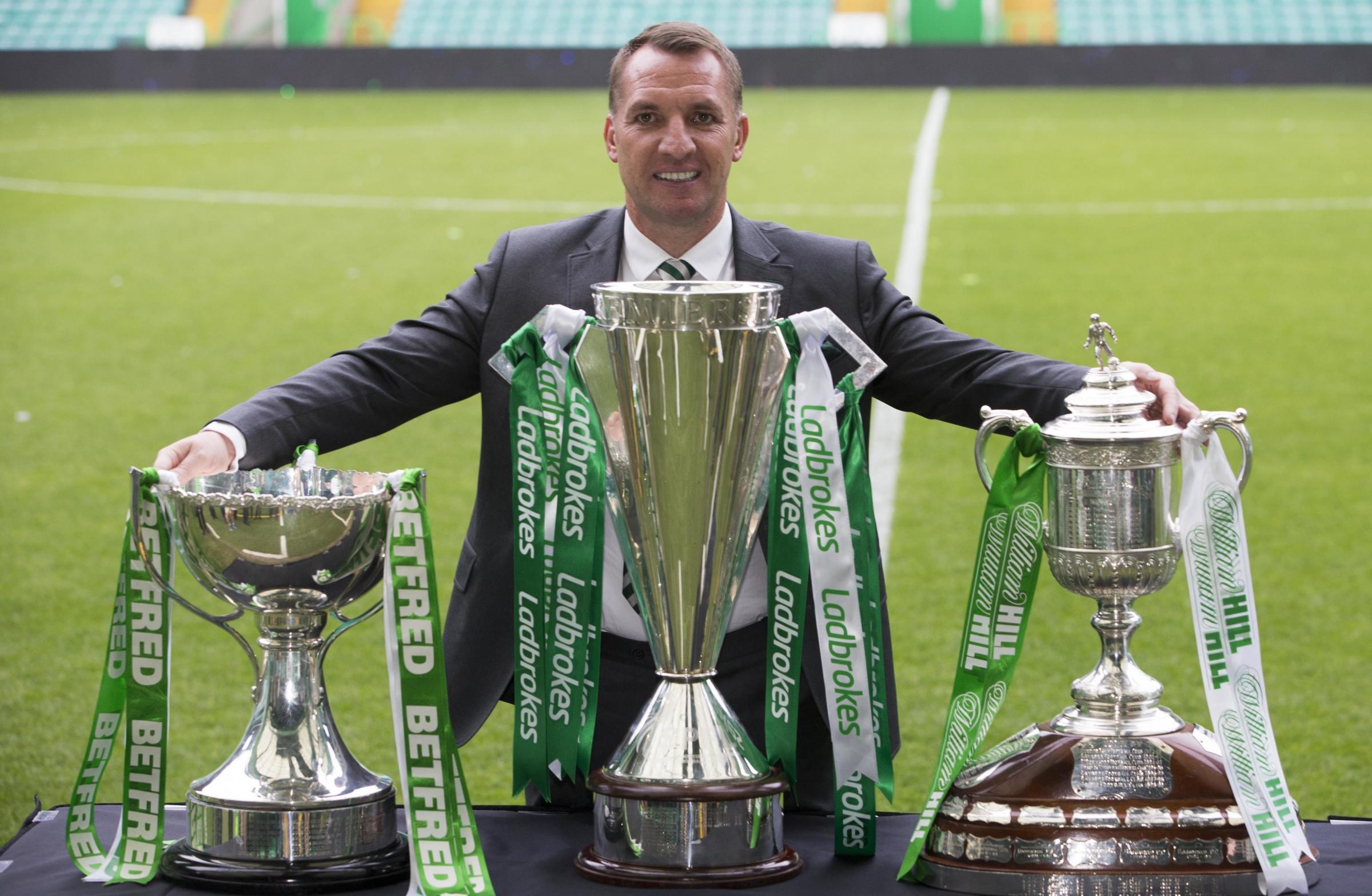  File photo dated 19-05-2018 of Celtic manager Brendan Rodgers poses with the three trophies during the parade at Celtic Park, Glasgow. PRESS ASSOCIATION Photo. Issue date: Tuesday February 26, 2019. Celtic have given Brendan Rodgers permission to speak