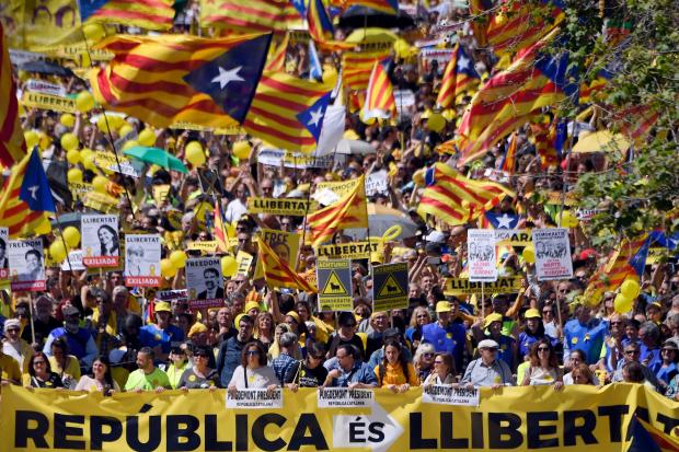 Demonstrators wave Catalan pro-independence lags as they march behind a banner reading "Republic is freedom" during a demonstration to support Catalan pro-independence jailed leaders and politicians. Photograph: Lluis Gene/AFP/Getty Images.